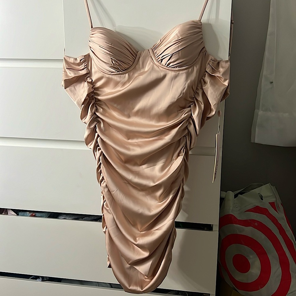 I am selling an Oh Polly pink dress. It is a light pink like a rose gold.